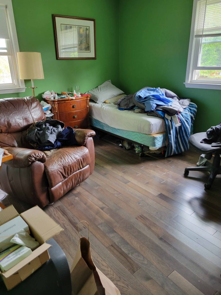 Cluttered bedroom before cleaning