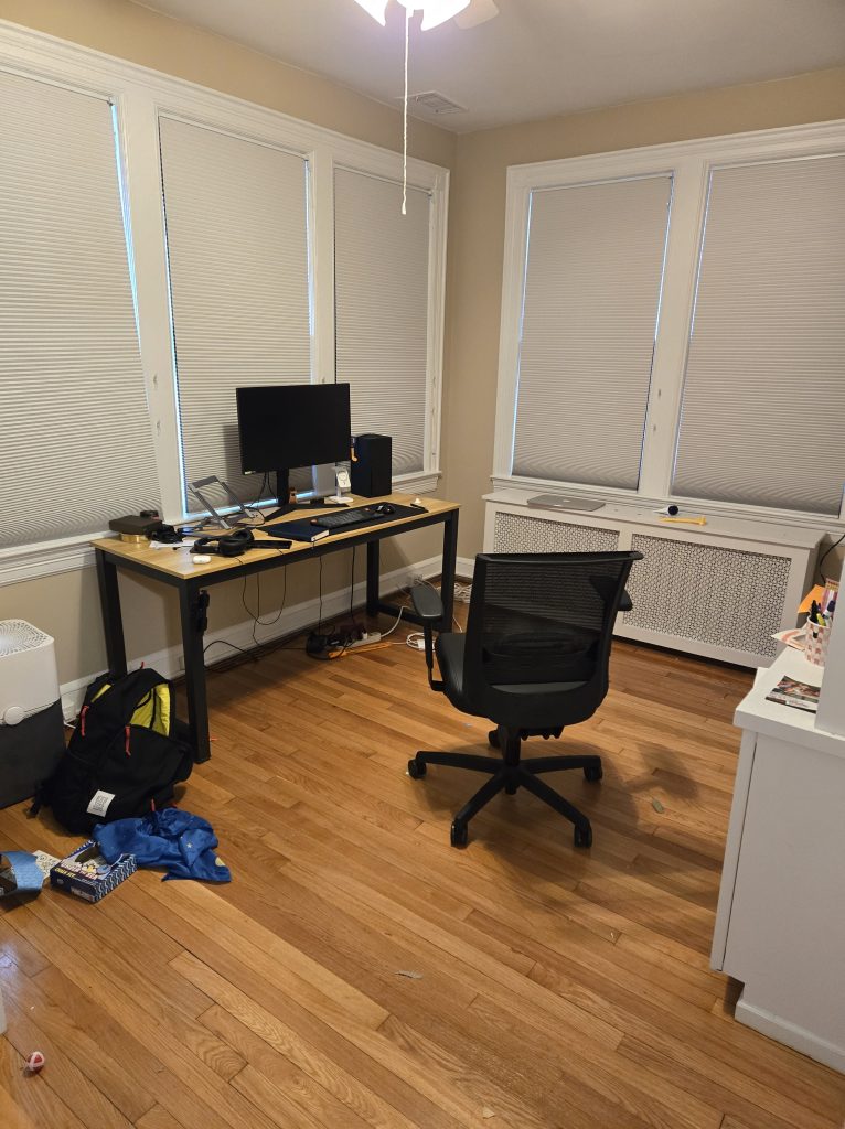 Clean room with wood floor and a desk
